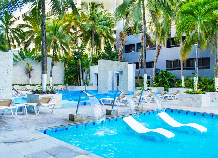 Pool with fountains and loungers inside the water at Oh! Cancun