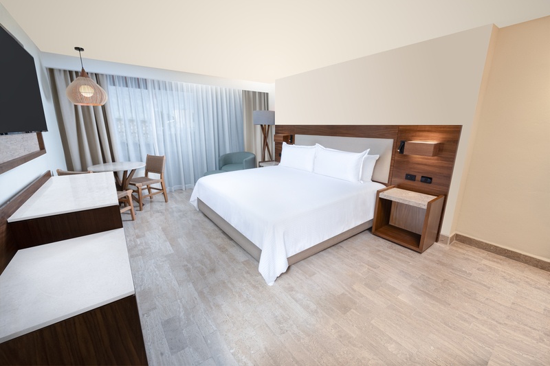 Standard Room with King Size bed decorated in gray, red, black and white in Oh! The Urban Oasis Hote